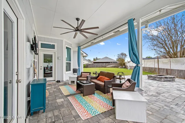 a living room with fireplace furniture and a large window