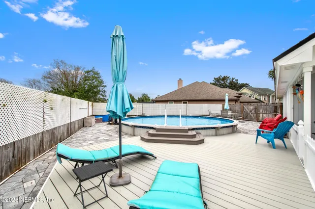a view of a swimming pool with a table and chairs