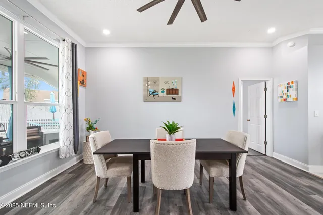 a view of a dining room with furniture window and wooden floor
