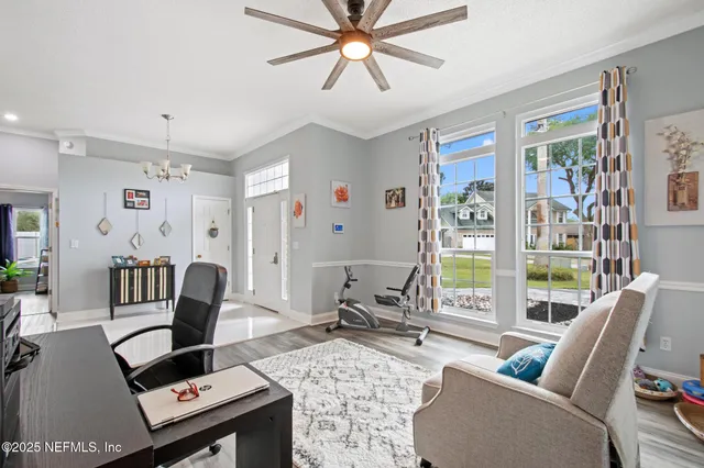 a living room with furniture and a floor to ceiling window