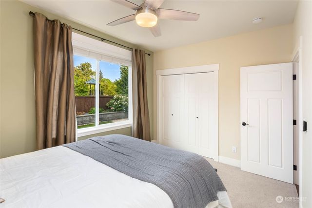 a bedroom with a large bed and a large window