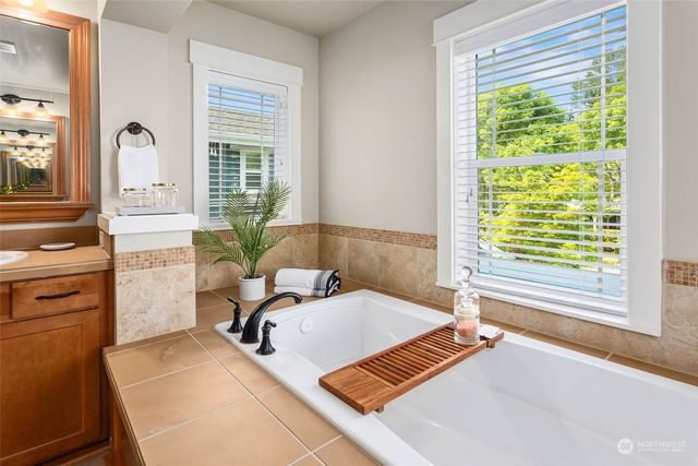 a bedroom with a bed and windows