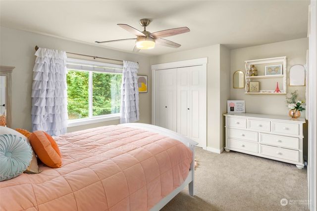 a bedroom with a large bed and a window