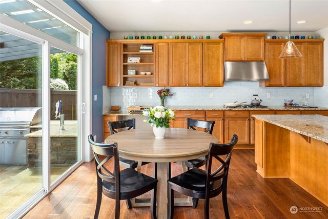a kitchen with a dining table chairs and chandelier