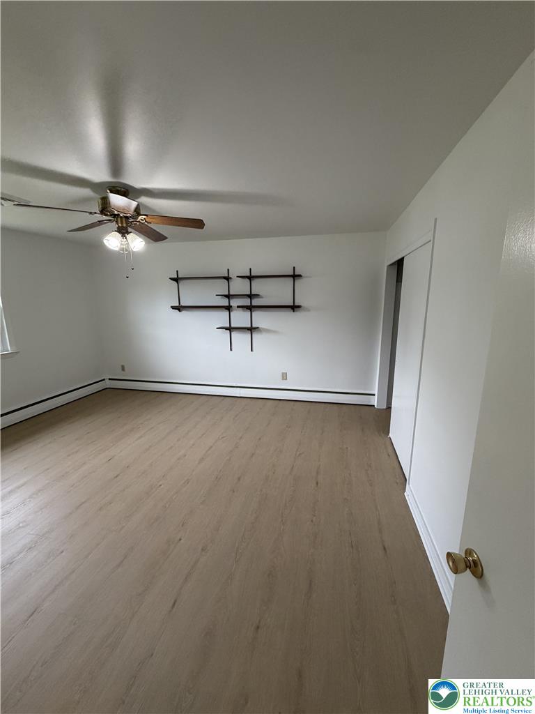 5391 Chapmans Road, Unit 2 Orefield, PA 18069 - Photo 17 of 22 A versatile living area features neutral tones and durable flooring, offering a blank canvas for personalization.