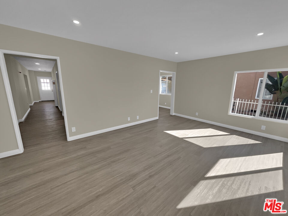 14538 Atlantic Avenue Compton, CA 90221 - Photo 3 of 18 a view of livingroom with hardwood floor and hallway