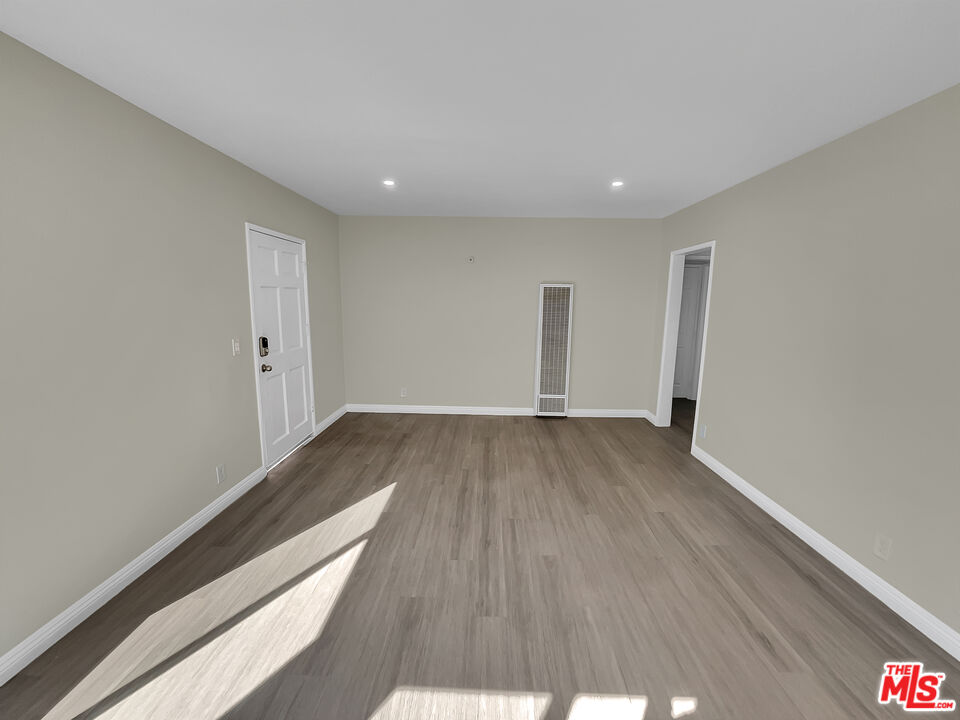14538 Atlantic Avenue Compton, CA 90221 - Photo 6 of 18 a view of wooden floor and windows in a room