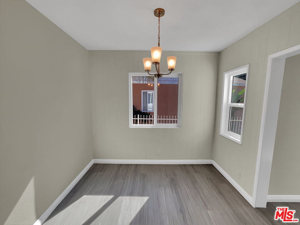 14538 Atlantic Avenue Compton, CA 90221 - Photo 8 of 18 a view of a room with wooden floor chandeliers and kitchen view