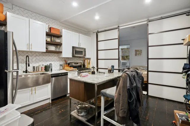 a kitchen with a sink appliances and cabinets