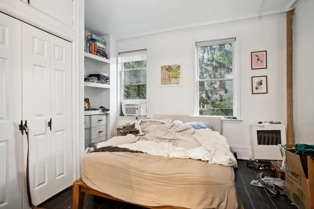 a bedroom with a bed and a window