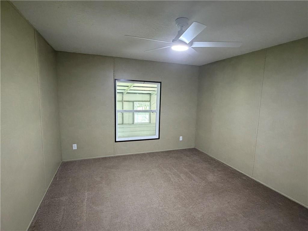 158 Kite Road Pittsview, AL 36871 - Photo 26 of 32 Neutral-toned walls with a single window, overhead lighting, and carpeted flooring