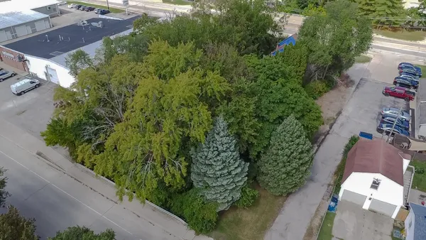 an aerial view of a house with a yard and garden