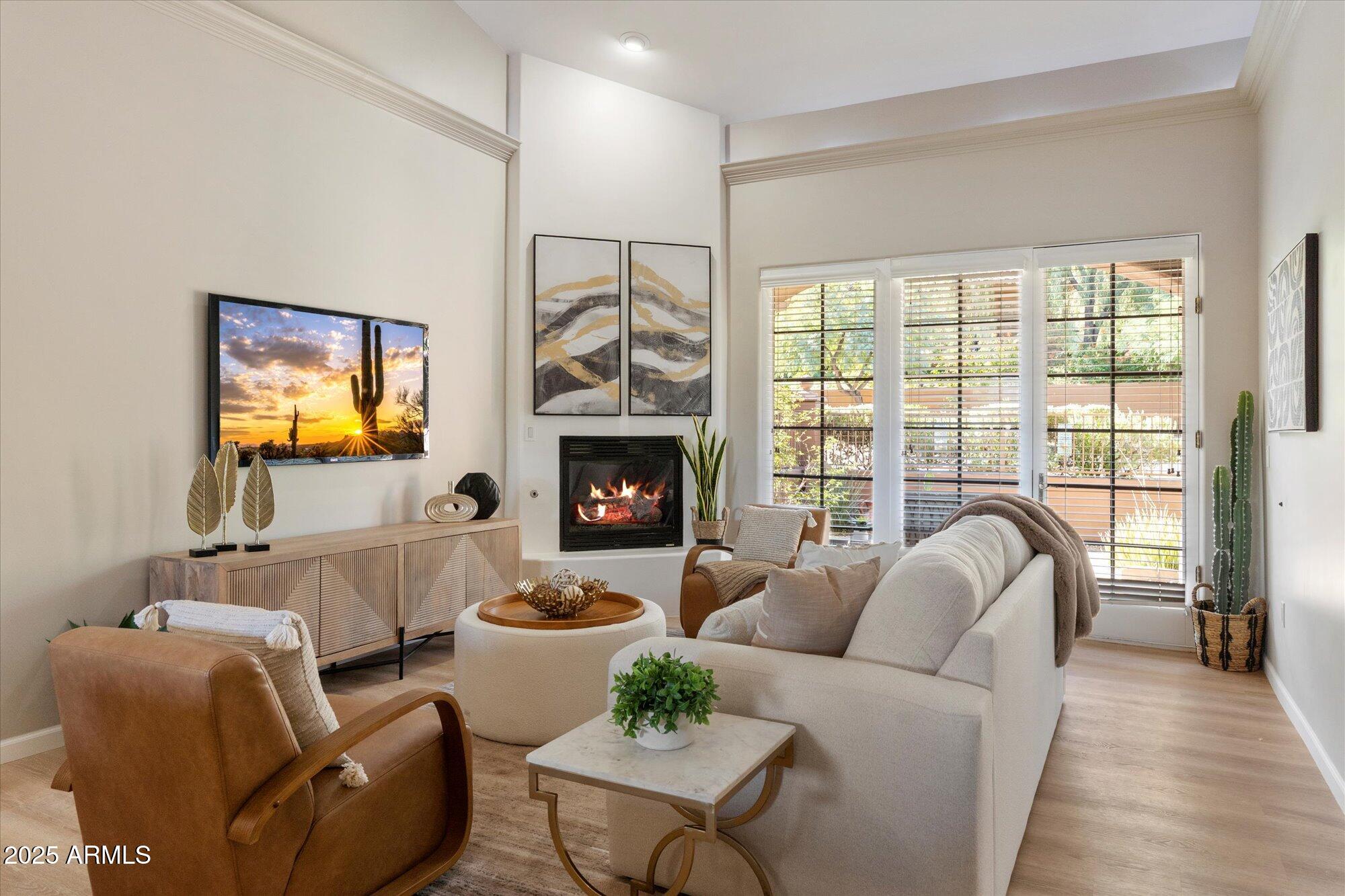 7200 East Ridgeview Place, Unit 9 Carefree, AZ 85377 - Photo 1 of 29 a living room with furniture a fireplace and a floor to ceiling window