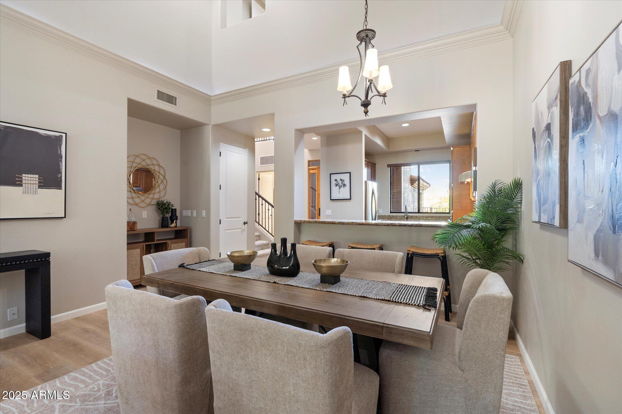 7200 East Ridgeview Place, Unit 9 Carefree, AZ 85377 - Photo 12 of 29 a dining room with furniture a livingroom and chandelier