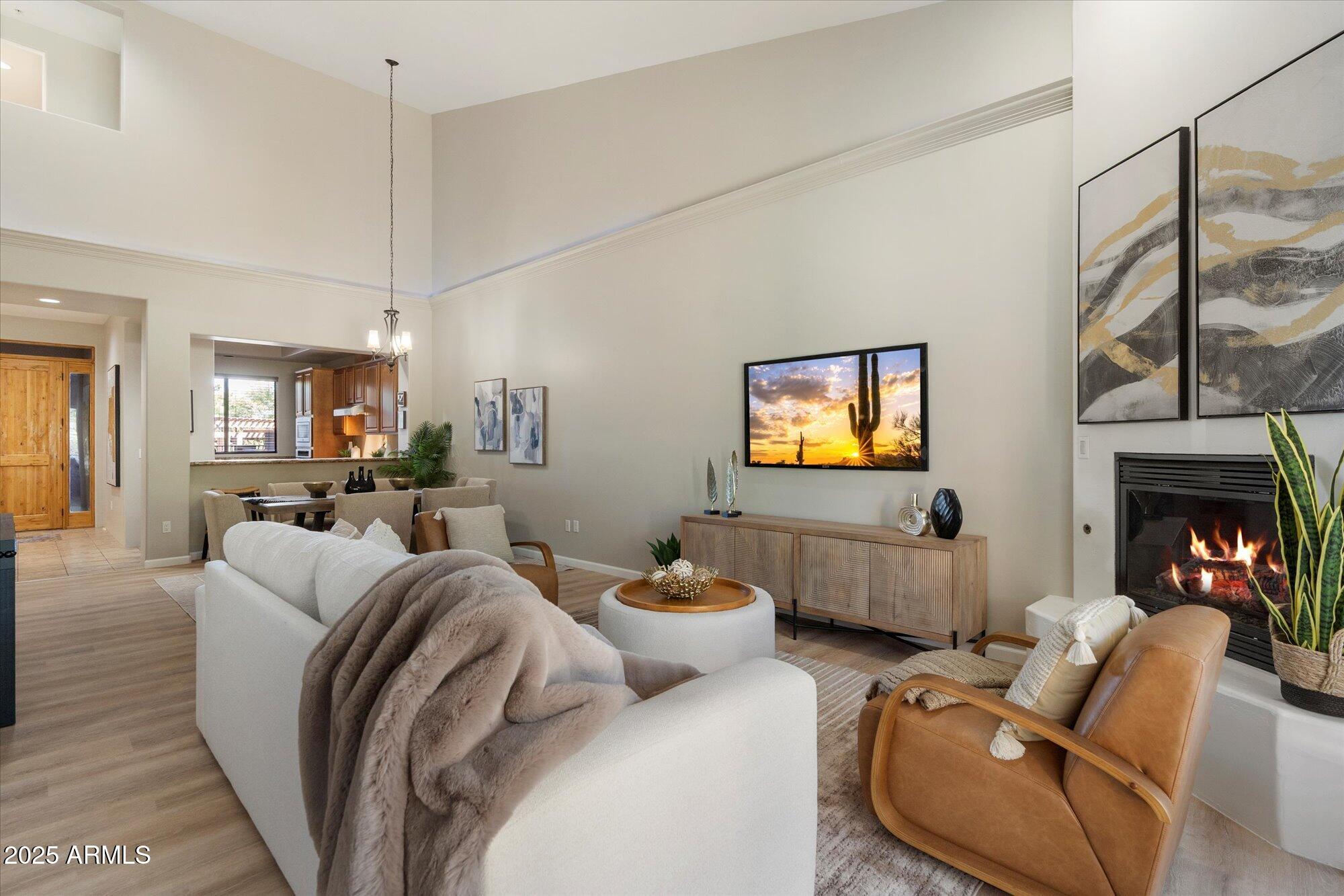 7200 East Ridgeview Place, Unit 9 Carefree, AZ 85377 - Photo 13 of 29 a living room with furniture a fireplace and a flat screen tv
