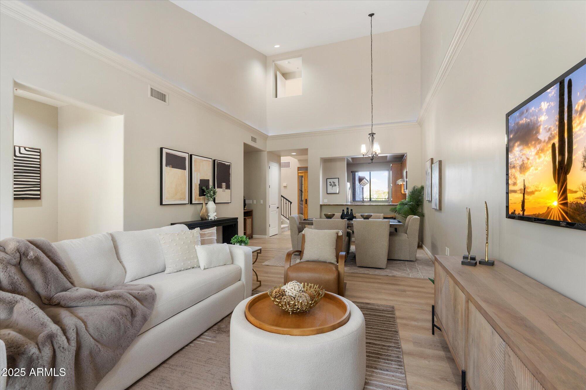 7200 East Ridgeview Place, Unit 9 Carefree, AZ 85377 - Photo 14 of 29 a living room with furniture a rug kitchen view and a chandelier