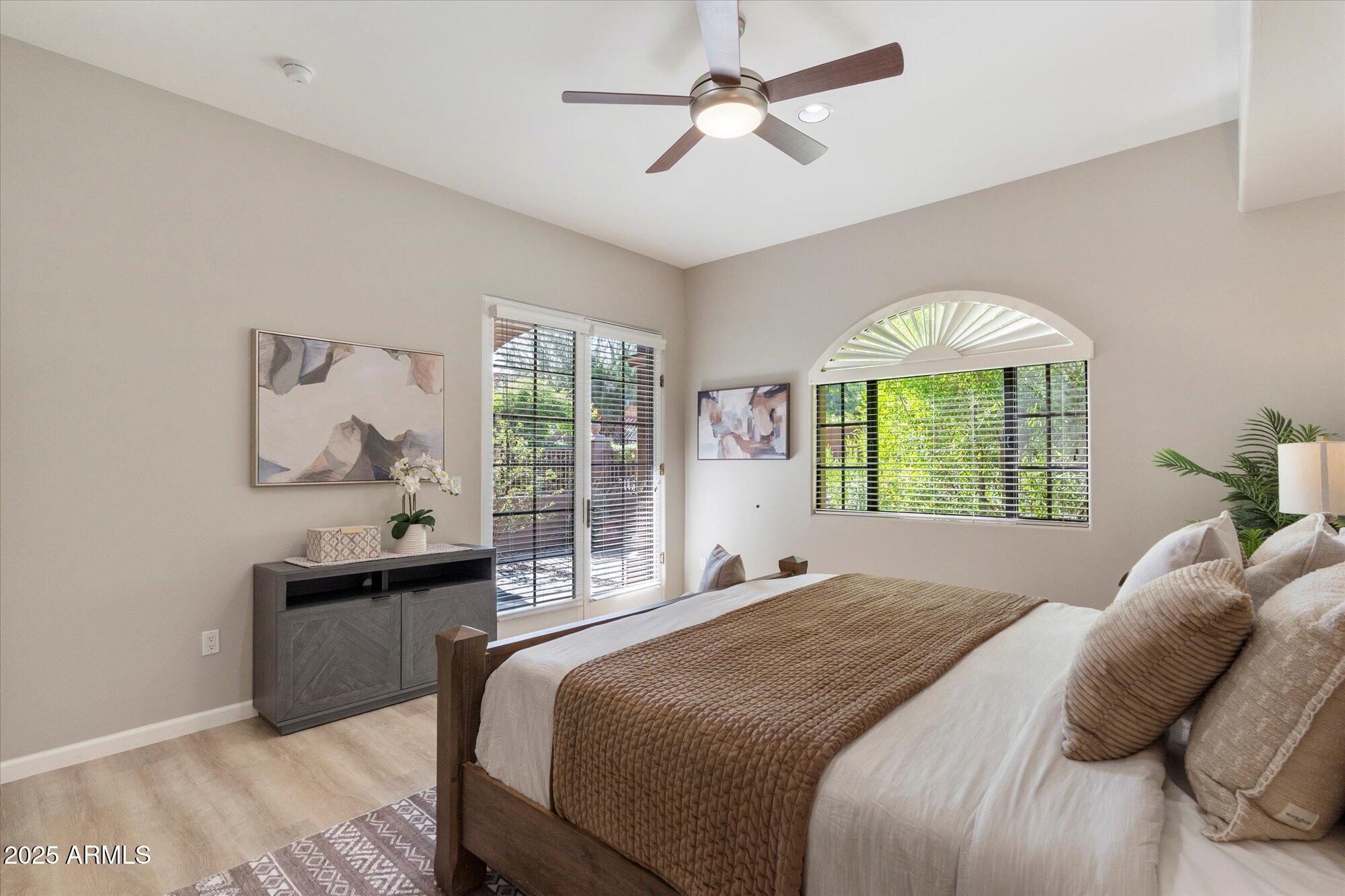 7200 East Ridgeview Place, Unit 9 Carefree, AZ 85377 - Photo 16 of 29 a bedroom with a bed and a chandelier