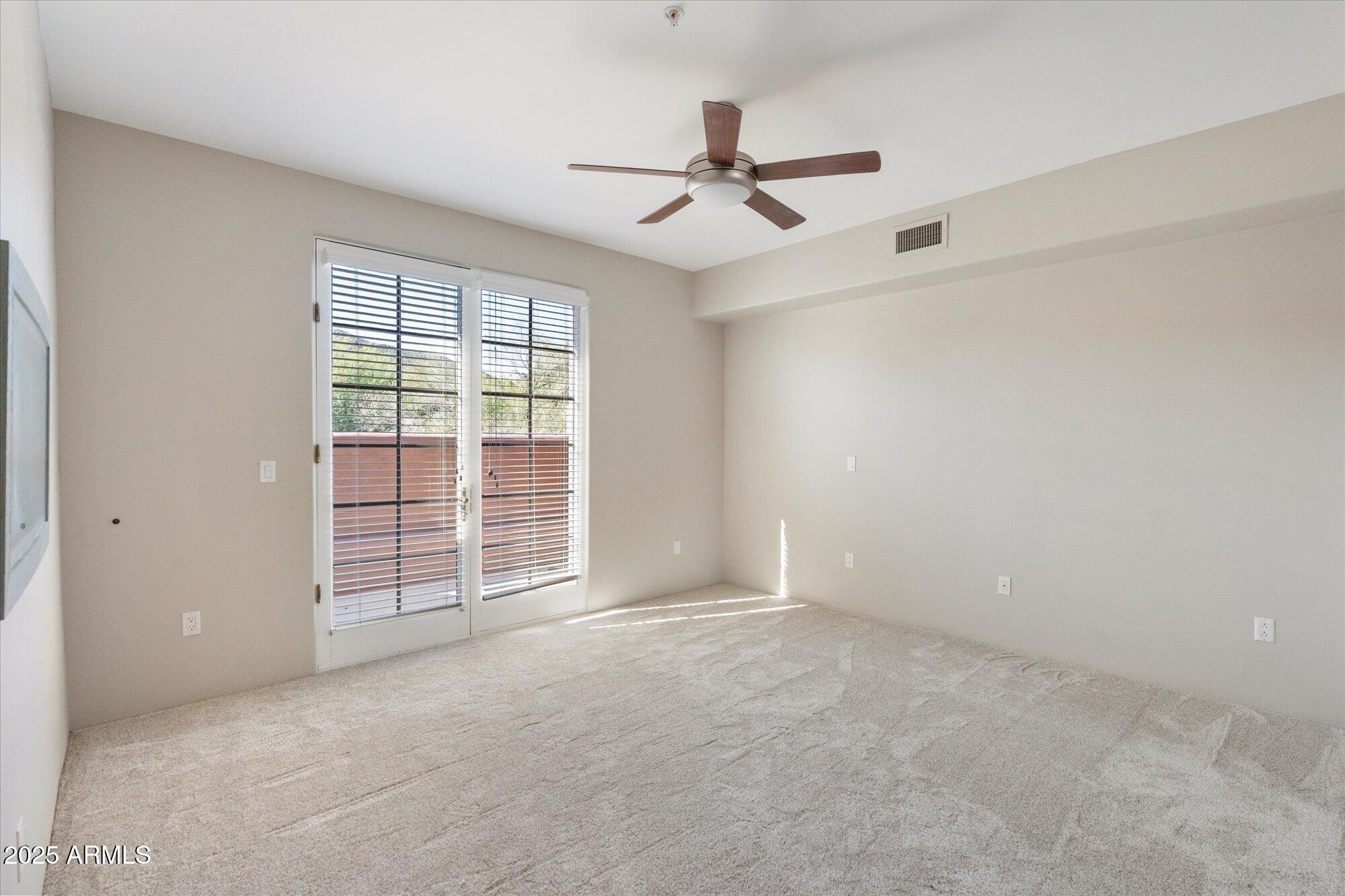 7200 East Ridgeview Place, Unit 9 Carefree, AZ 85377 - Photo 20 of 29 a view of an empty room with a window