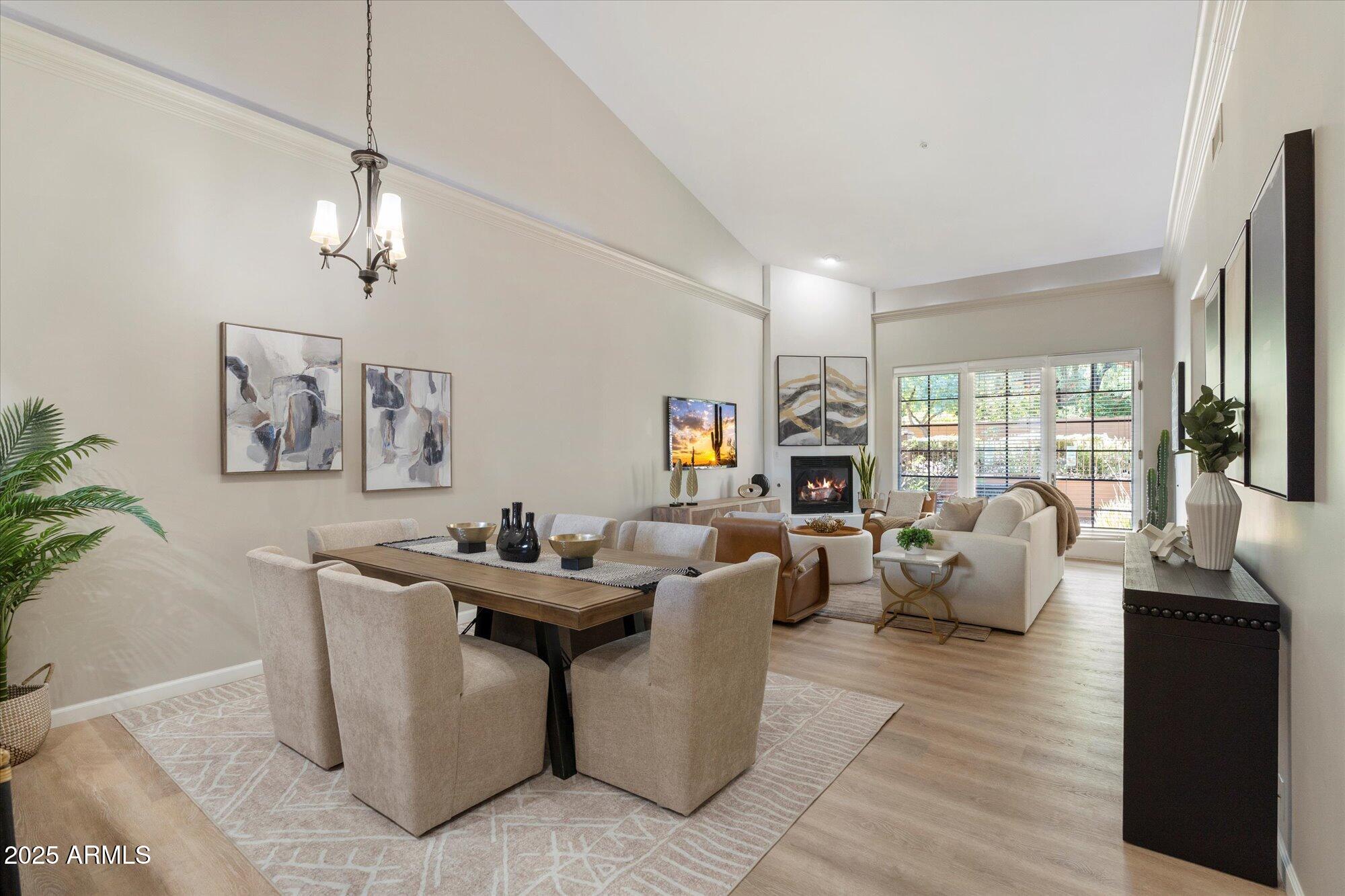 7200 East Ridgeview Place, Unit 9 Carefree, AZ 85377 - Photo 2 of 29 a living room with fireplace furniture and a chandelier