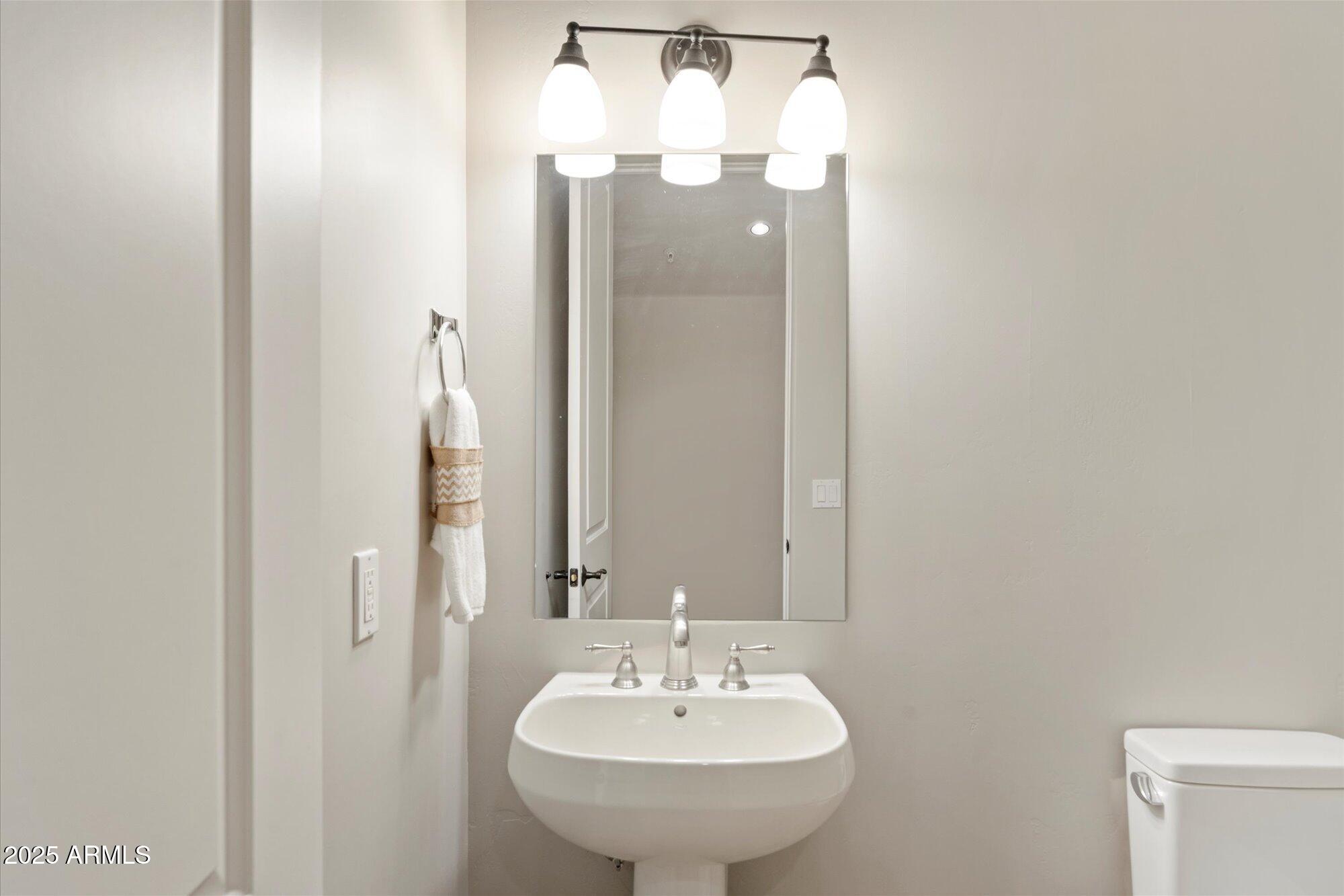 7200 East Ridgeview Place, Unit 9 Carefree, AZ 85377 - Photo 26 of 29 a bathroom with a sink and a mirror