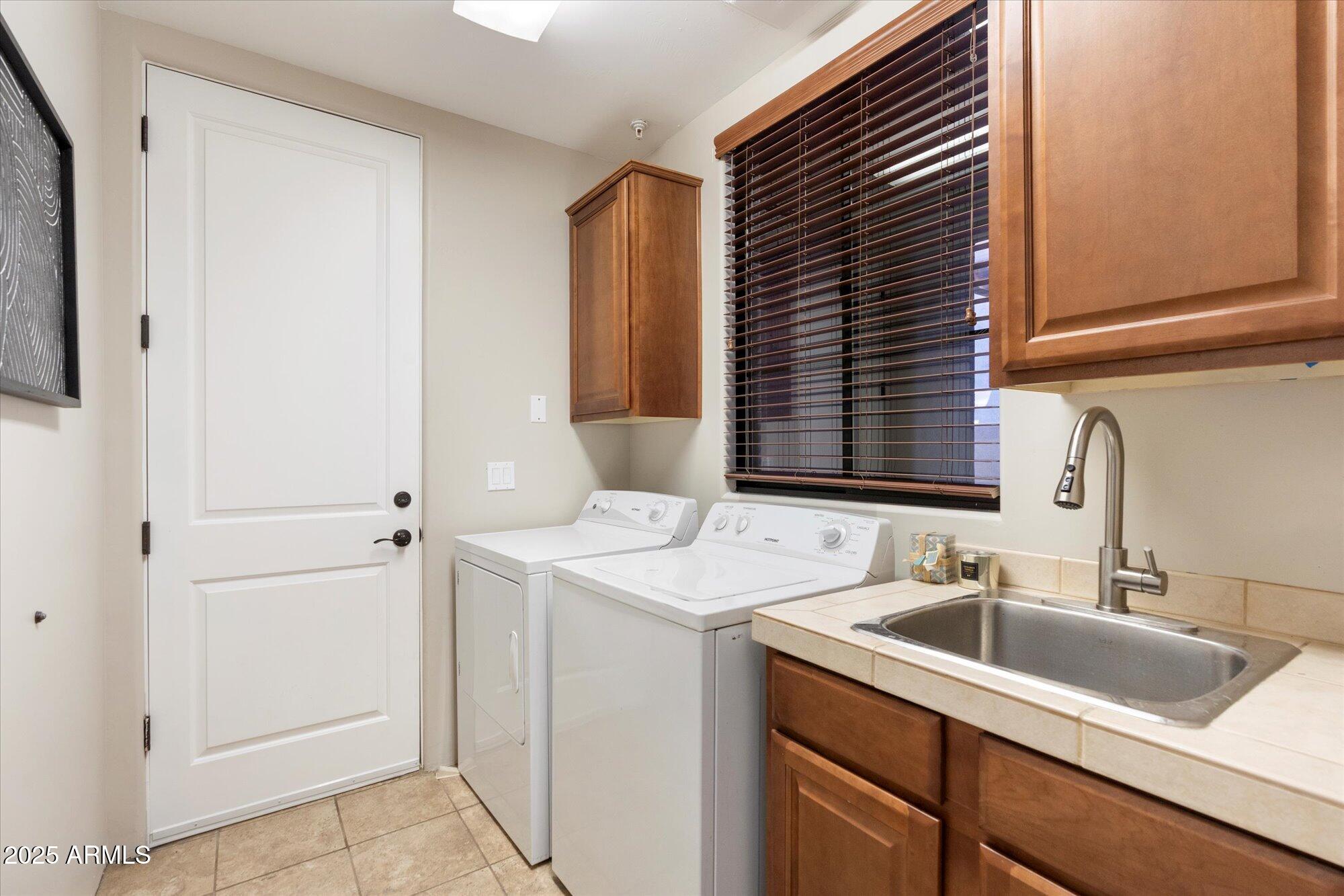7200 East Ridgeview Place, Unit 9 Carefree, AZ 85377 - Photo 27 of 29 a kitchen with a sink and cabinets