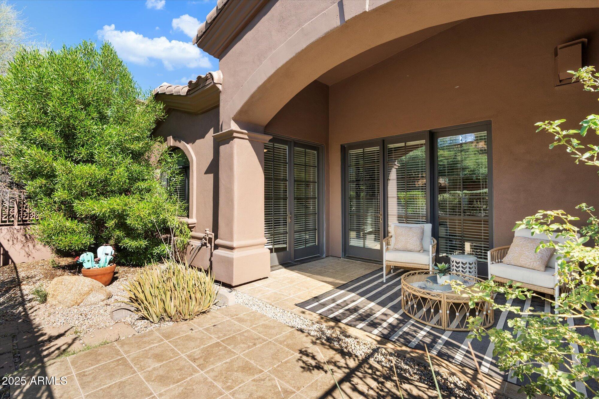 7200 East Ridgeview Place, Unit 9 Carefree, AZ 85377 - Photo 28 of 29 a view of a chairs and table in patio
