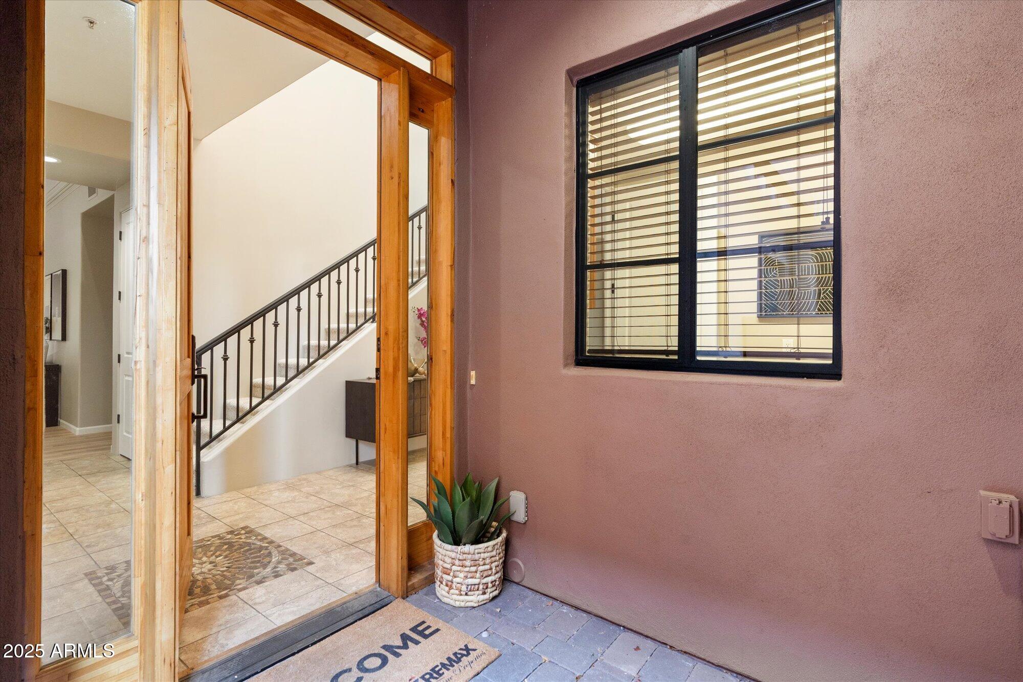 7200 East Ridgeview Place, Unit 9 Carefree, AZ 85377 - Photo 7 of 29 a view of a hallway with wooden floor and a potted plant
