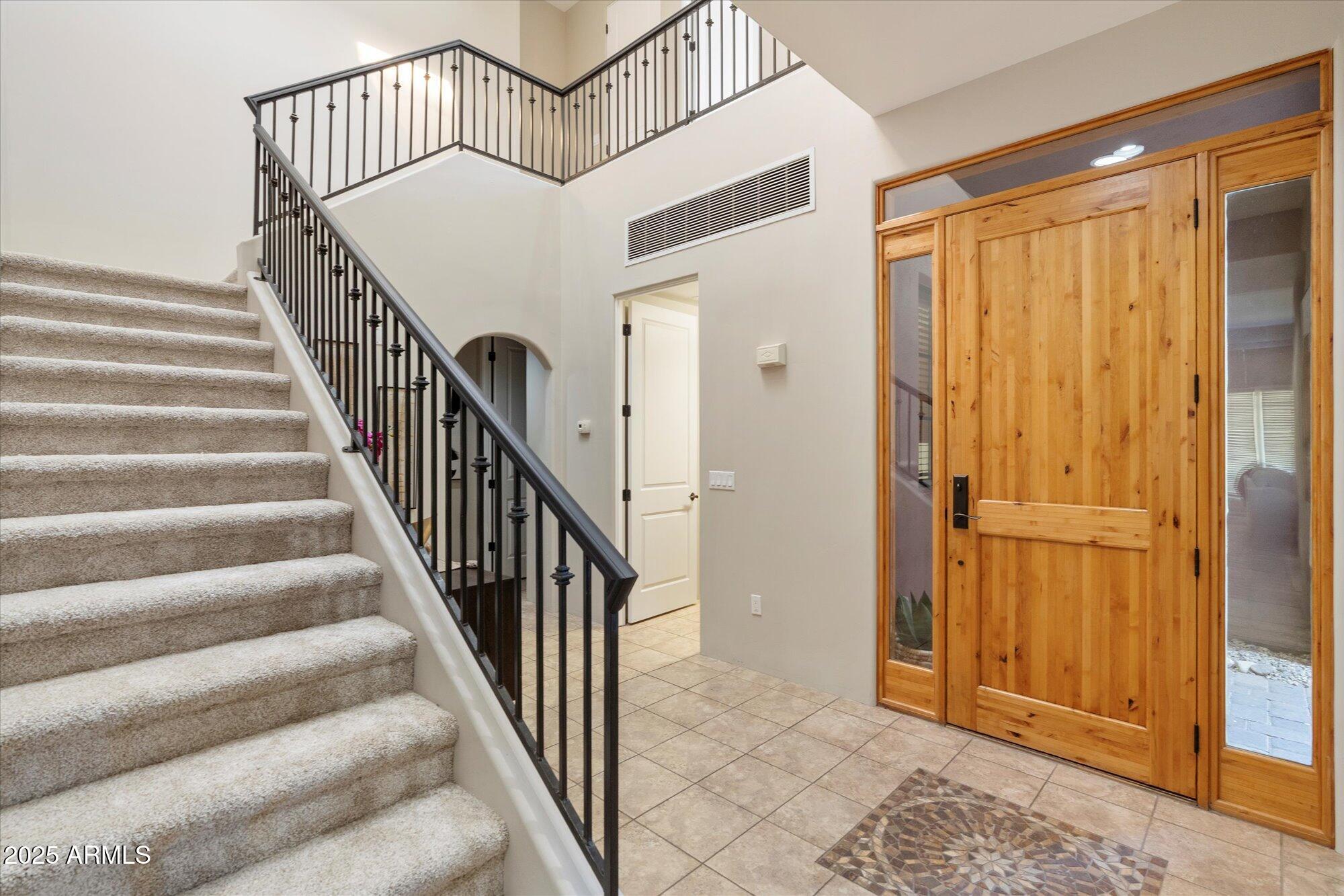 7200 East Ridgeview Place, Unit 9 Carefree, AZ 85377 - Photo 9 of 29 a view of staircase with railing and white walls