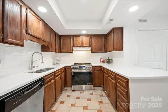 a kitchen with stainless steel appliances a sink stove and cabinets