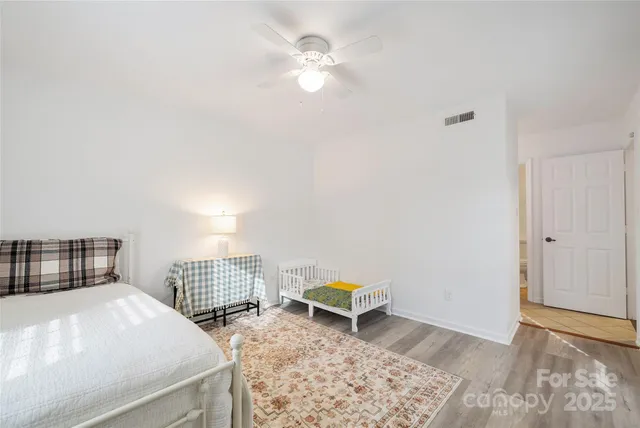 a bedroom with a bed and a stool