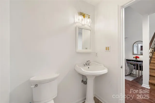 a bathroom with a sink toilet and a mirror