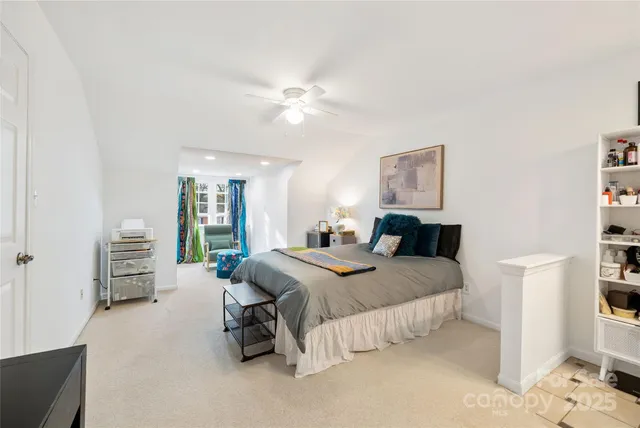 a bed room with a bed and a chandelier