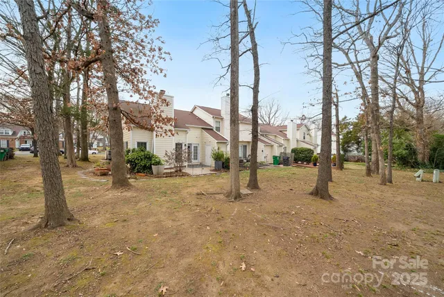 a view of house with backyard and deck