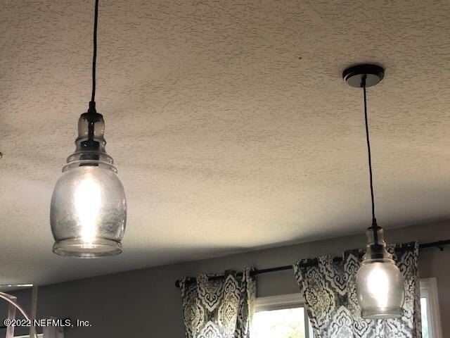 8220 Fouraker Forest Road Jacksonville, FL 32221 - Photo 28 of 56 PENDANT LIGHTING OVER KITCHEN ISLAND