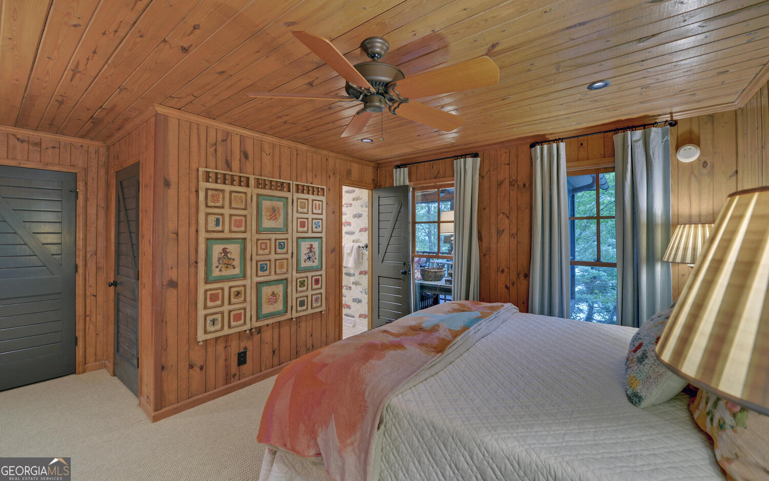 3540 Lake Rabun Road Lakemont, GA 30552 - Photo 15 of 81 a spacious bedroom with a large bed and a chandelier