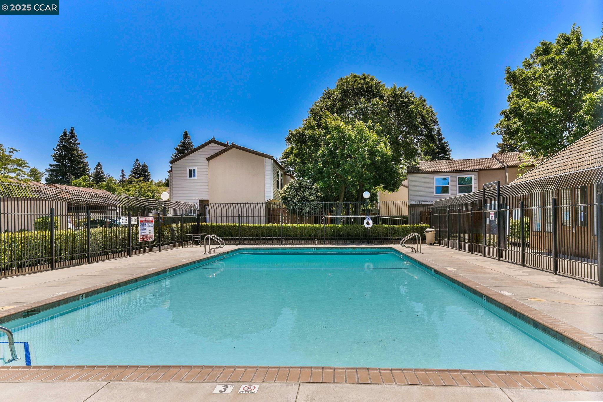 1435 Bel Air Drive, Unit C Concord, CA 94521 - Photo 21 of 25 a view of a house with pool fire pit a table and chairs