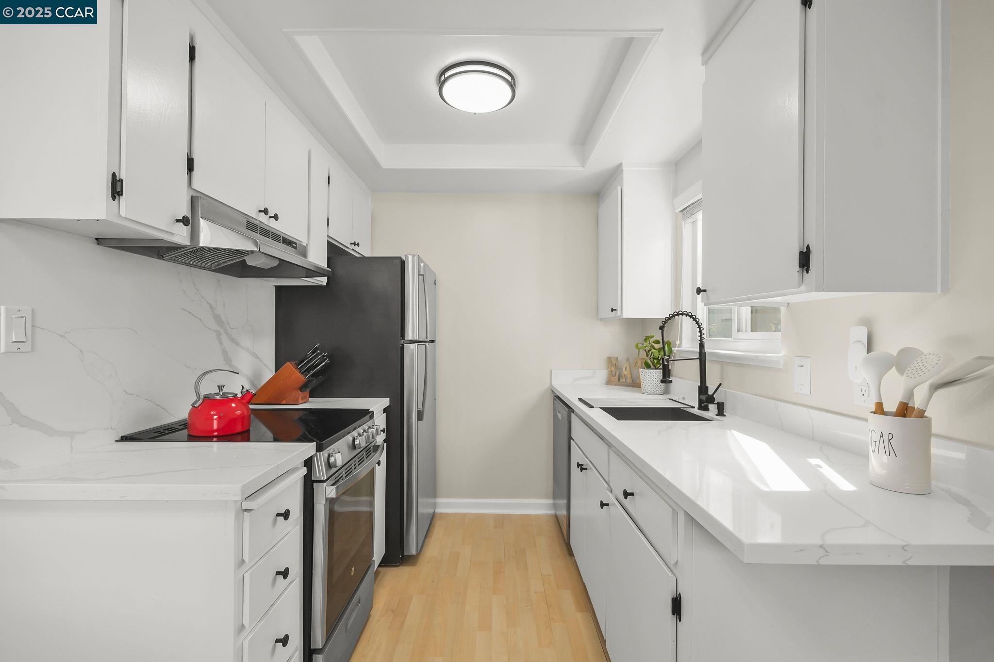 1435 Bel Air Drive, Unit C Concord, CA 94521 - Photo 4 of 25 a kitchen with stainless steel appliances granite countertop a sink stove and refrigerator