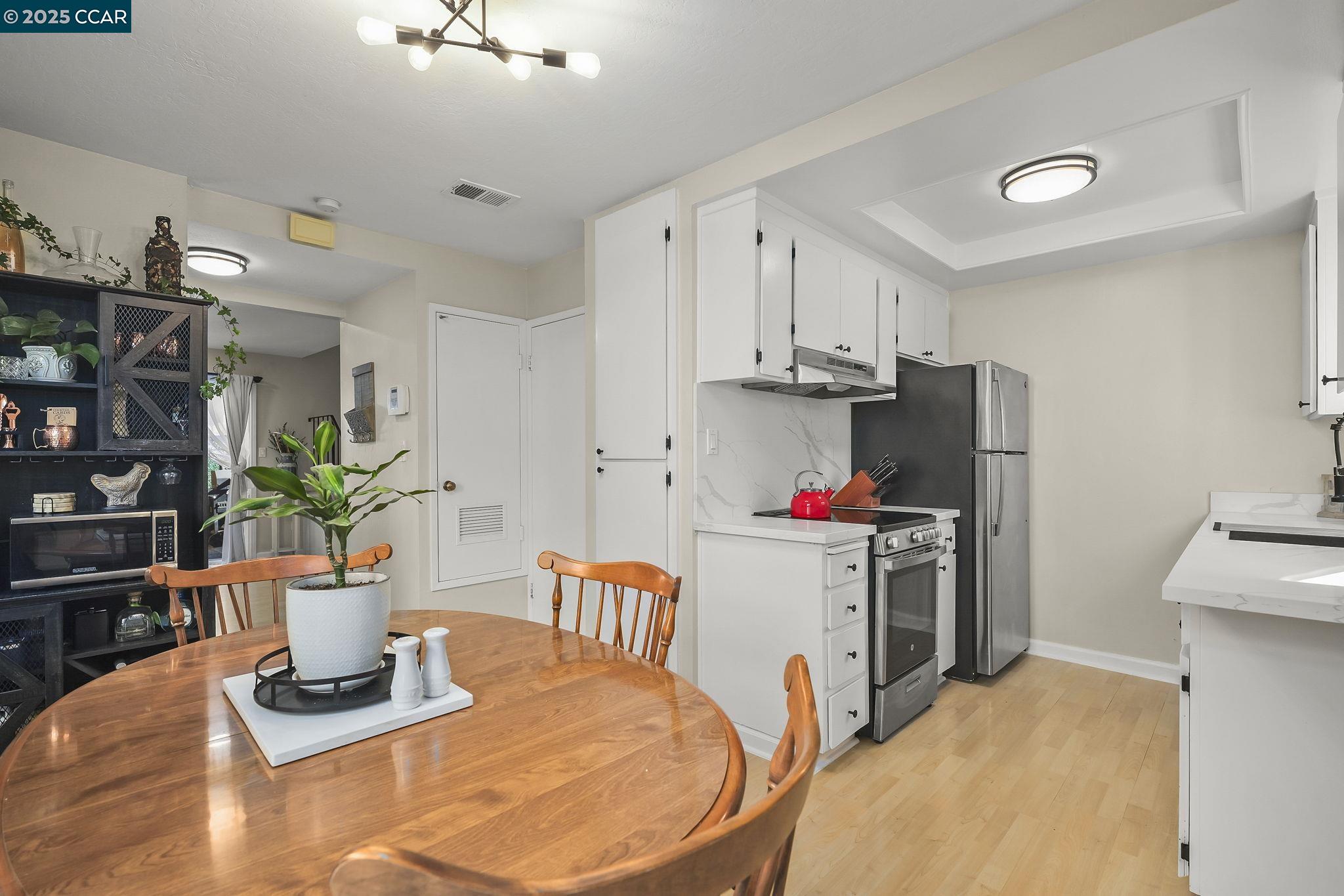 1435 Bel Air Drive, Unit C Concord, CA 94521 - Photo 7 of 25 a view of a kitchen with appliances and a dining table