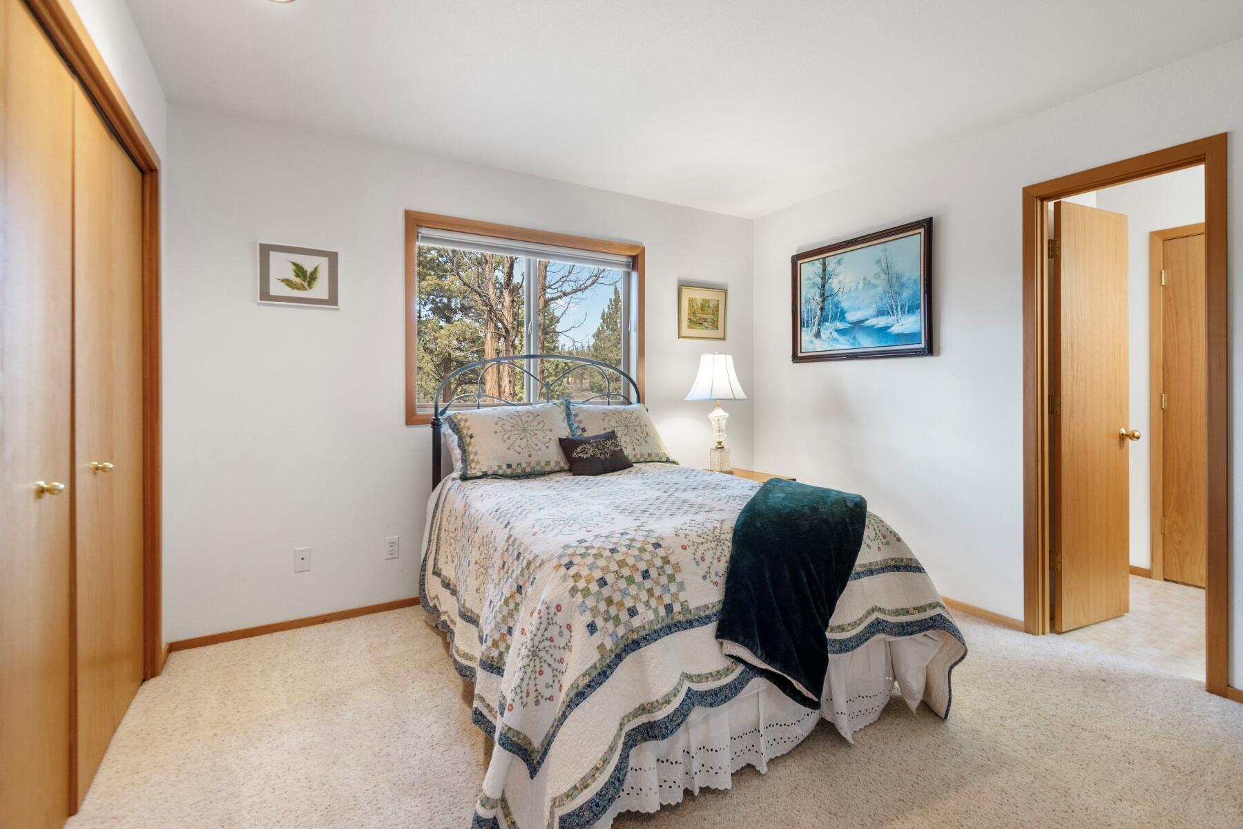 64585 Joe Neil Road Bend, OR 97701 - Photo 19 of 35 a bedroom with a bed and a painting on the wall