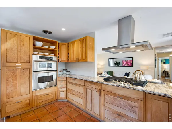 a kitchen with stainless steel appliances granite countertop a stove and cabinets