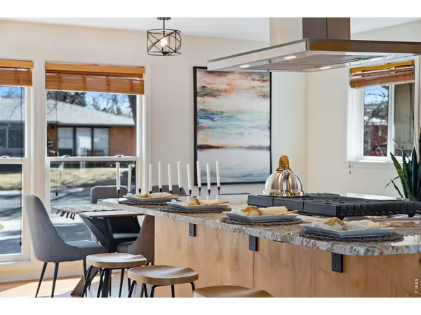 a kitchen with a counter top space and a view of living room