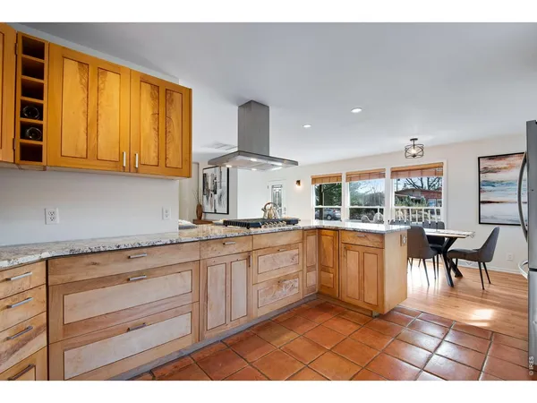 a kitchen with granite countertop a sink cabinets and window