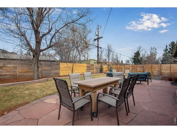a view of a backyard with a patio and outdoor seating