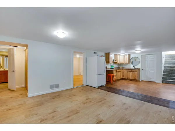 a view of an empty room with wooden floor