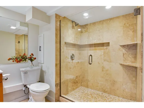 a bathroom with a toilet sink and shower
