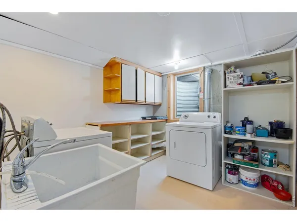 a utility room with sink dryer and washer