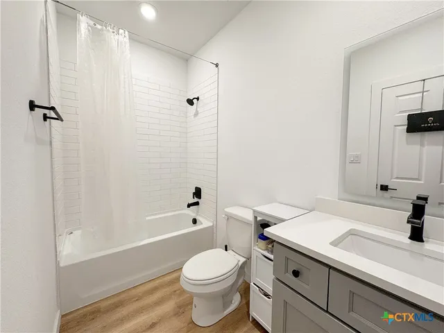 a bathroom with a sink a toilet and a bathtub