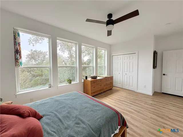 a bedroom with a large bed and a large window