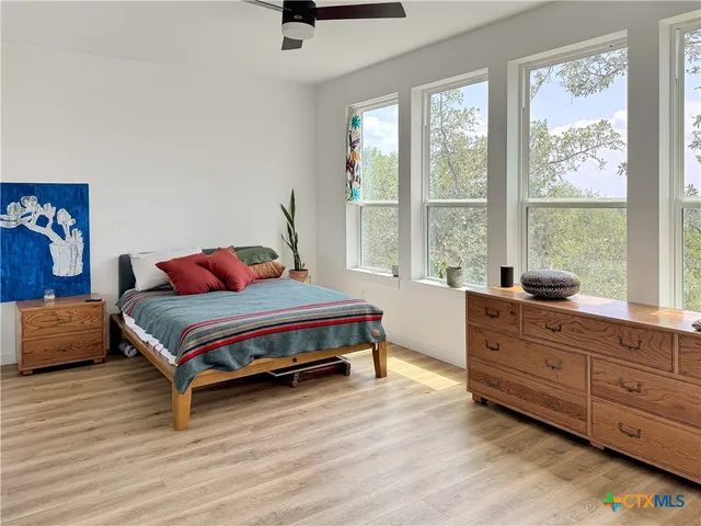 a bedroom with a bed and window