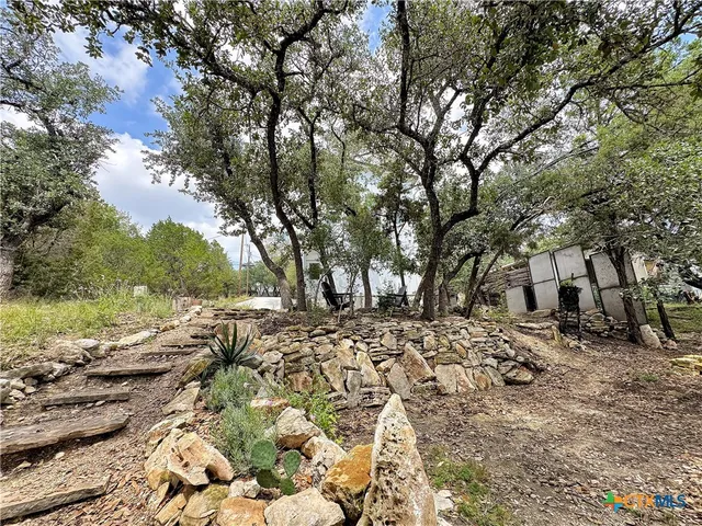 an aerial view of a house with lots of trees